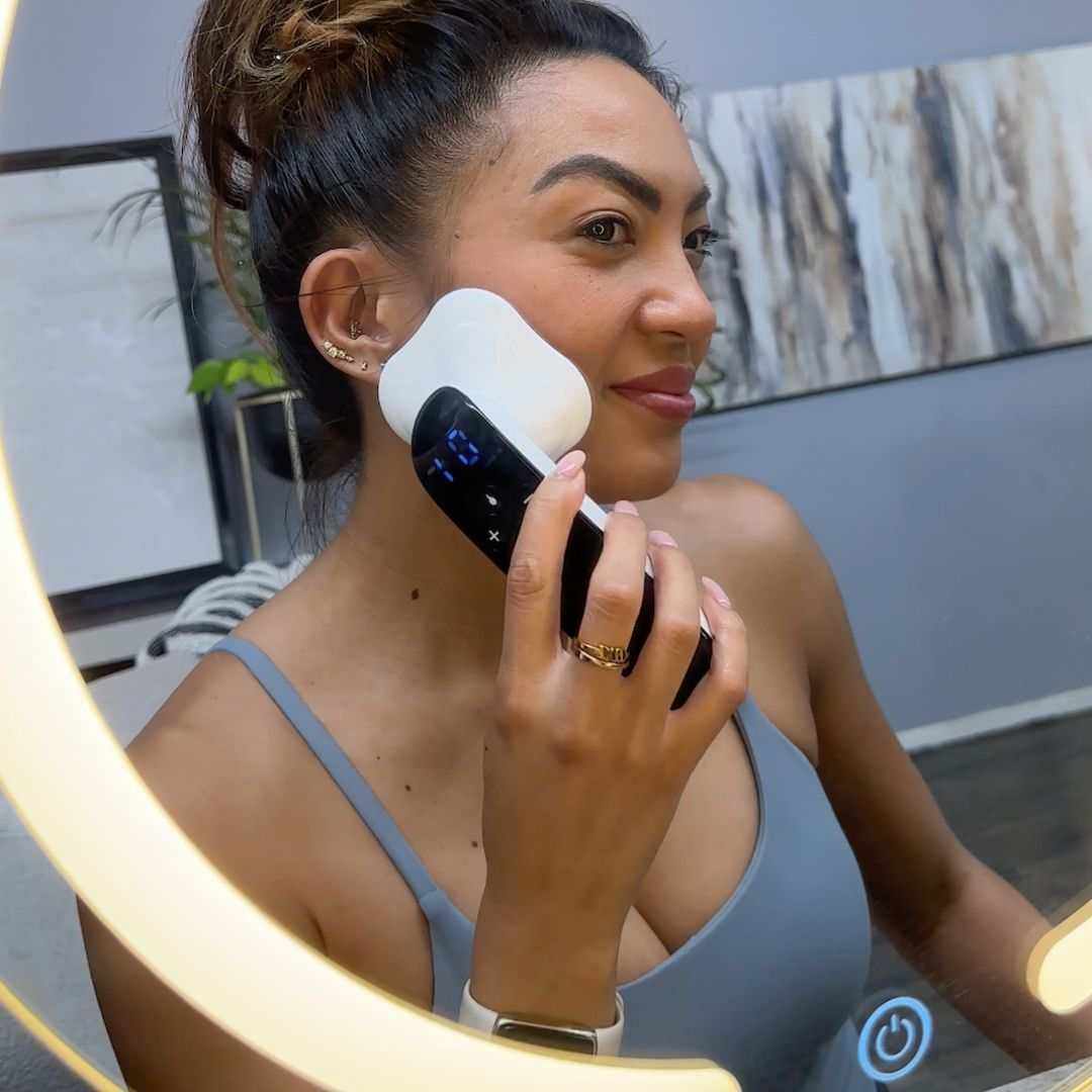 Woman using AdoreKart Ultrasonic Fat Removal Machine in front of a mirror, promoting facial toning and shaping.